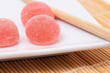 Sweet Strawberry Flavored Fruit Mochi on a Light Bamboo Mat
