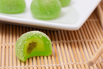 Sweet Green Melon Flavored Fruit Mochi on a Bamboo Mat