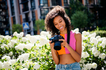 Photo of attractive young cheerful lady photographer enjoy street photography wear colorful garment...
