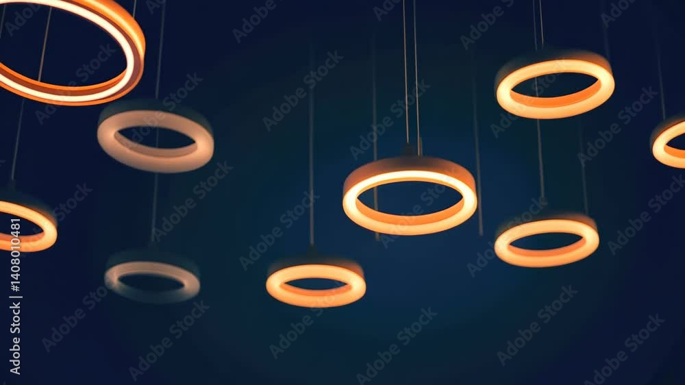Poster illuminating rings suspended from the ceiling create a captivating display of light and shadows in a