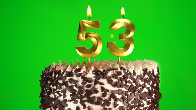 Burning candles number 53 on birthday cake against chroma key background. Fifty-third birthday. Birthday celebration