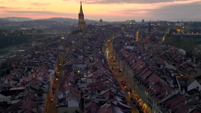 Illuminated City of Bern in Switzerland from above in Night Twilight - the Capital city Evening view. Aerial Drone shot.