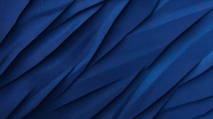 Obraz premium Textured deep blue fabric with intricate folds and shadows, creating a dynamic visual effect