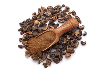 A wooden scoop filled with organic dried Gooseberry (Phyllanthus emblica) or Amla powder, placed on a heap of gooseberry fruits, isolated on a white background.