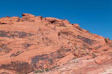 Desert varnish or rock varnish. Aztec Sandstone(Jurassic) geological formation. weathering. Scenic...