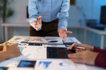 Business people having a meeting and analyzing financial reports using documents and digital...