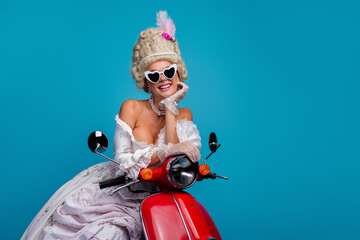 Elegant woman in a vintage baroque gown on a scooter embodying aristocracy and modern style on a...