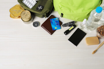 Survival kit. Different emergency supplies on white wooden table, above view. Space for text