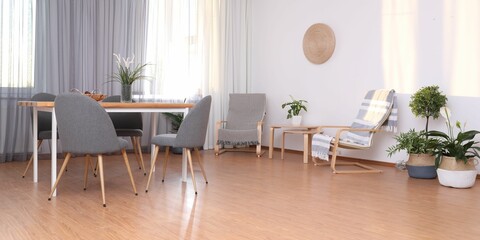 Windows with stylish curtains in living room interior