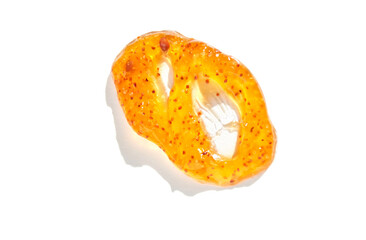 Close up of bright orange sliced kiwano fruit with seeds on white background.