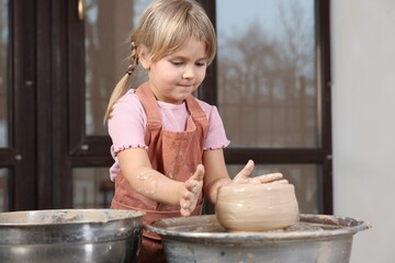 Hobby and craft. Little girl making pottery indoors