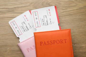 Travel agency. Flight tickets and passports on wooden table, top view