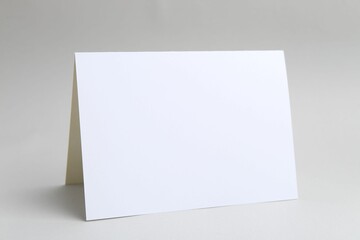One blank greeting card on light background
