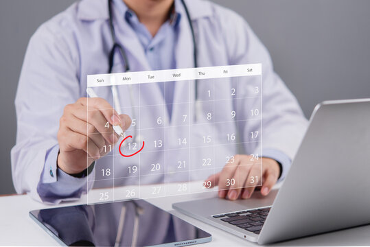 Doctor working on a laptop while selecting a date on a calendar, representing medical scheduling and healthcare management.