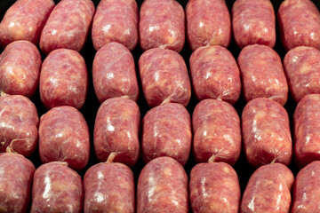 Raw Sausages Background on a Frying Pan. Process of Preparing Tasty Hotdogs. Unhealthy Food. Meat for Grill Barbeque