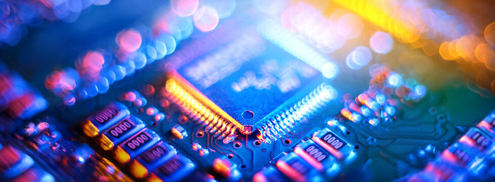 Computer Microchips and Processors on Electronic circuit board. Abstract technology microelectronics concept background. Macro shot, shallow focus.