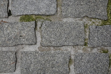 Weathered Stone Wall with Mossy Growth in Between Stones