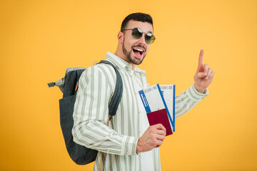 Excited traveler holding travel documents and gesturing while preparing for an upcoming trip to an...