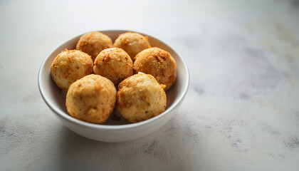 Fototapeta premium Crispy sabudana vada in bowl. Tasty Indian snack. Delicious food. Cooking and culinary concept.