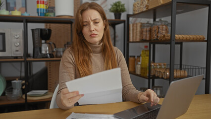 Woman in office reading document with laptop searching for information while surrounded by shelves indoors conveying workplace setting involving young female professional