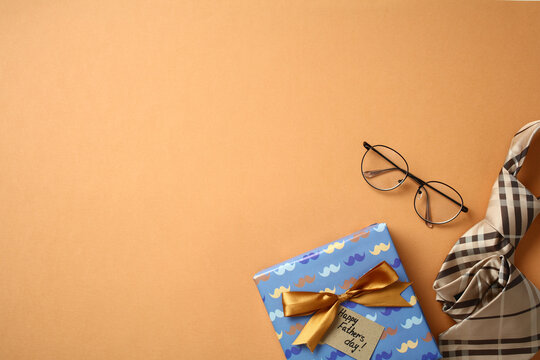 Top view of a Father's Day gift with glasses and a necktie