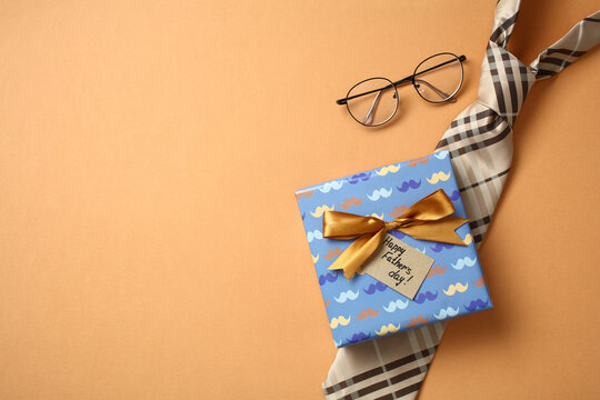 Top view of a Father's Day gift with tie and glasses