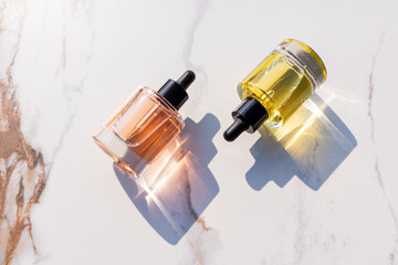 Transparent cosmetic oil bottles casting shadows