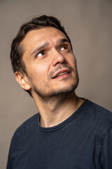 Fototapeta premium A close-up portrait of a man with striking facial features and deep, expressive eyes. A mix of strength, character, and emotion captured in a single moment