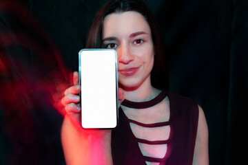 Woman holding smartphone with blank white screen display