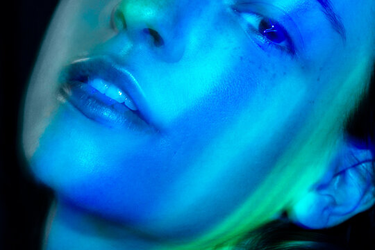 Artistic close up portrait with blue neon lighting