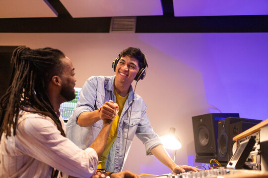 Musicians Collaborating and Celebrating in Recording Studio