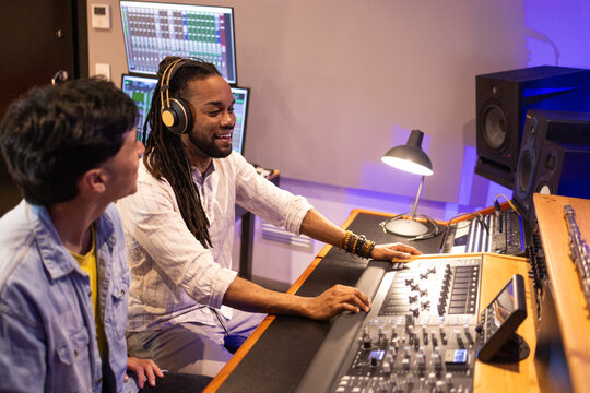 Professional sound engineers collaborating in studio