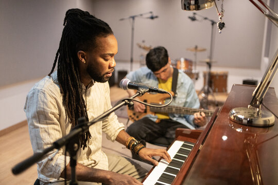 Musicians Creating Harmony in Modern Recording Studio
