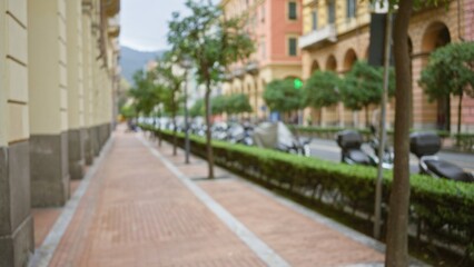 Defocused street scene in la spezia, italy, showing a blurred view of an urban sidewalk lined with...