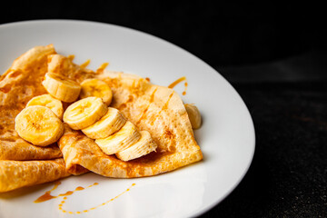 Crepes sweet banana syrup pancakes breakfast dish dessert organic product fresh tasty gourmet food background on the table rustic food top view copy space
