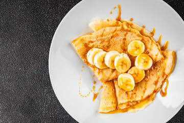 Crepes sweet banana syrup pancakes breakfast dish dessert organic product fresh tasty gourmet food background on the table rustic food top view copy space