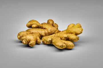 Fresh ginger root with peel isolated on white background with space for text