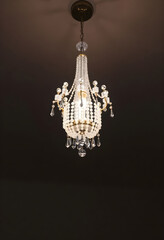 Fototapeta premium chandelier hanging from a ceiling in a dark room