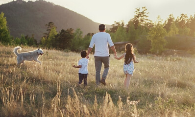 Dad with kids and dog walks in nature