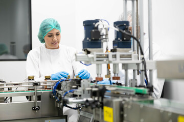 In a laboratory, a professional examines products on a production line, emphasizing quality...
