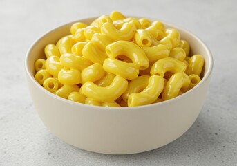 A bowl filled with creamy macaroni and cheese on a light surface in a close up shot view here
