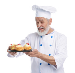 Professional pastry chef with delicious profiteroles on white background