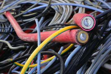 used electric cables in the container of the recycling center for the separate collection of...