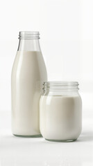 Milk in glass bottles and jars on white background