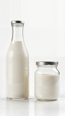 Milk in glass bottles and jars on white background