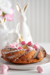 Traditional Easter cakes with icing decorated candies on white wooden table