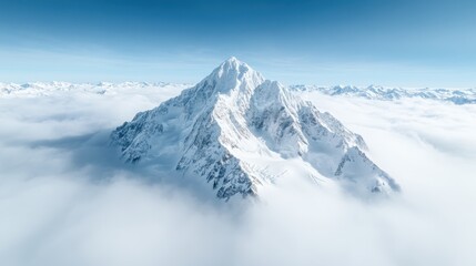 Obraz premium An ethereal view of a snowy mountain peak surrounded by soft clouds, creating a dreamlike atmosphere that embodies tranquility, mystery, and the beauty of nature.
