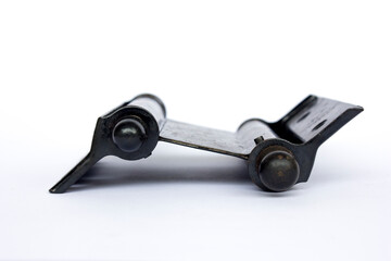 An old rusty black hinge on plain white background.