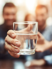 Soft-focus image of a woman handing a glass of water. Clean, refreshing, and caring visual.