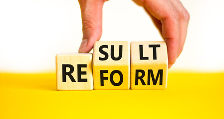 Reform and result symbol. Concept words Reform Result on beautiful wooden block. Beautiful yellow...